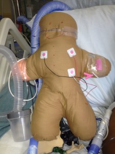 Child with asthma created this "mini me" complete with pulsox, cardiac leads, IV, and high flow nasal cannula.